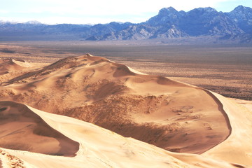 Fototapeta na wymiar Massive sand dunes in Death Valley National Park desert in the winter golden and blue sky