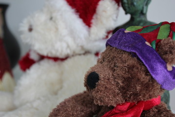 Two Christmas teddie bears side by side.