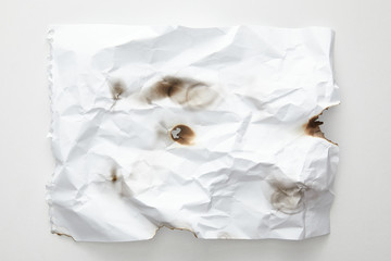 top view of empty crumpled and burnt vintage paper on white background