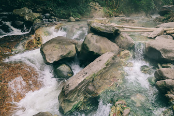 A close up on the hot spring merging with cold river creating a perfect temperature of water in...