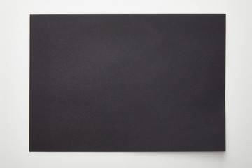 top view of empty black paper on white background