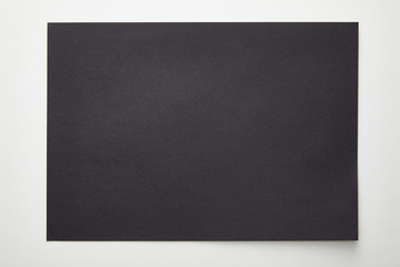 Fototapeta premium top view of empty black paper on white background