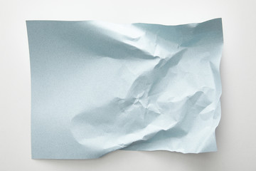 top view of empty crumpled blue paper on white background