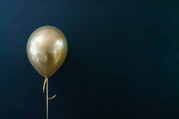 golden balloon on a dark background. Holiday Concept, Postcard - obrazy, fototapety, plakaty