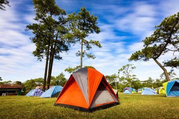 Red tent at campground with long exposure blue sky.