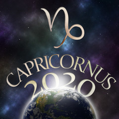 Symbol of the zodiac sign Capricornus and its name with the year 2020 appearing behind the earth with stars and the universe in the background