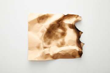 top view of empty crumpled and burnt beige vintage paper on white background