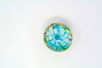 paperweight with blue flower with white background 