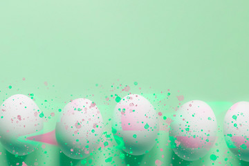 Easter eggs on mint background with trendy glitch effect and color spatter