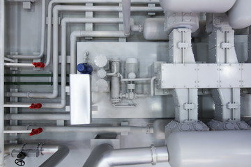 industrial background of pipes and gate valves with electric motors