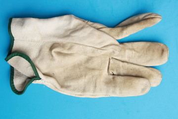 used leather work gloves in color background