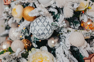 Christmas tree decorations. Different christmas ornaments, angels, balls, snowflakes on the tree. Christmas decorations design.