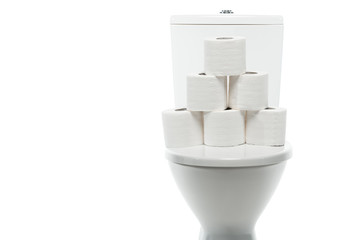 ceramic clean toilet bowl with rolls of toilet paper isolated on white