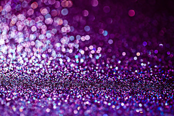 Purple glitter raster festive background. Abstract violet blurred circles. Bokeh lights with bright shiny effect illustration. Overlapping glowing and twinkling spots decorative backdrop design.