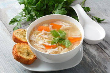 Chicken soup with noodles and vegetables in bowl. Healthy food concept