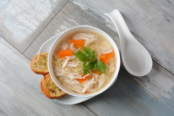 Chicken soup with noodles and vegetables in bowl. Healthy food concept