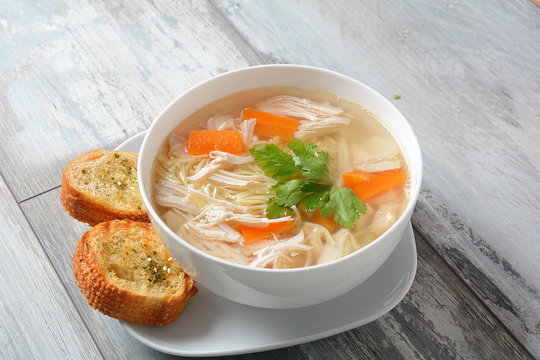 Chicken soup with noodles and vegetables in bowl. Healthy food concept