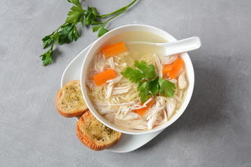 Chicken soup with noodles and vegetables in bowl. Healthy food concept