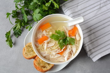 Chicken soup with noodles and vegetables in bowl. Healthy food concept