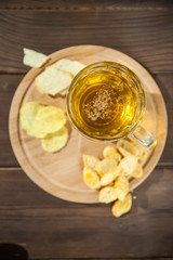 Beer glass with beer and hot smoked fish close-up. Beer mug with beer and fish on a dark background and copy space.