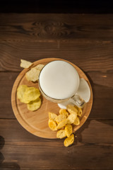 Beer glass with beer and hot smoked fish close-up. Beer mug with beer and fish on a dark background and copy space.