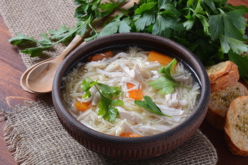 Chicken soup with noodles and vegetables in bowl. Healthy food concept