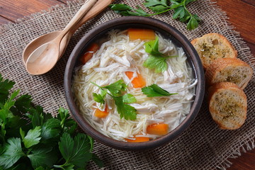 Chicken soup with noodles and vegetables in bowl. Healthy food concept