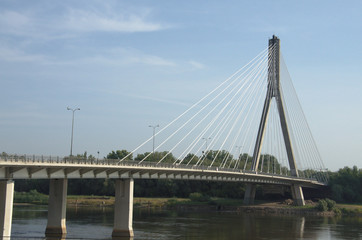 Fototapeta na wymiar The Swietokrzyski modern Bridge on the Vistula River in Warsaw, Poland