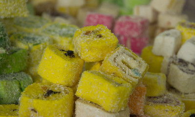 Assorted traditional turkish delight . traditional sweets, rahat lukum in counter in the market.
