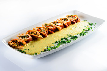 chicken rolls with kari sauce on a white