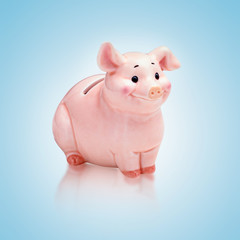 rosa farbenes sparschwein isoliert auf blauem fond