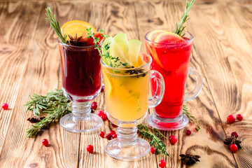 set of three types of hot tea, punch and mulled wine on an old rustic background