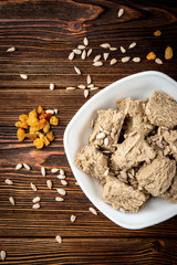 Sunflower halva on dark wooden background.