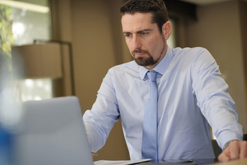Fototapeta premium Businessman being thoughtful in front of laptop