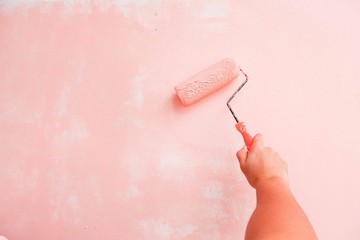 Painter paints pink wall