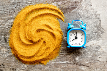 Deadline concept. Clock near sand on grey background top-down