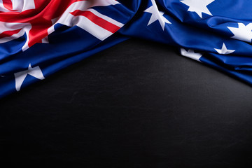 Australia day concept. Australian flag with the text Happy Australia day against a blackboard background. 26 January. - obrazy, fototapety, plakaty