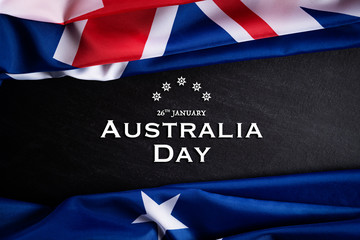 Fototapeta na wymiar Australia day concept. Australian flag with the text Happy Australia day against a blackboard background. 26 January.