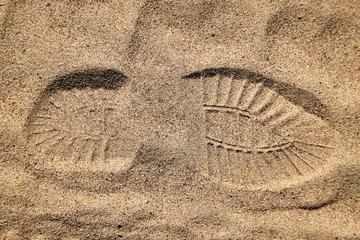 Footprint on the yellow sand for background or texture