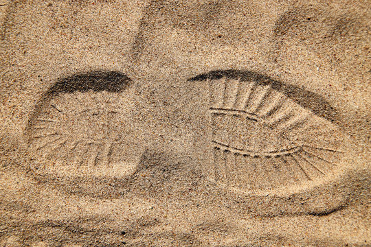 Footprint on the yellow sand for background or texture