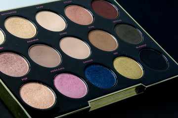 Naklejka premium Make-up colorful eyeshadow palettes isolated on black background. View from above. 