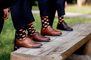 stylish men's socks. Stylish suitcase, men's legs, multicolored socks and new shoes. Concept of...