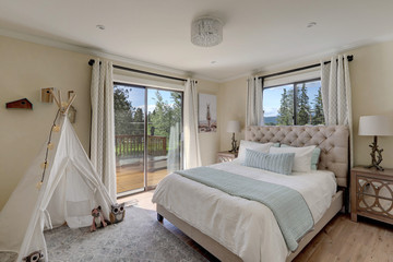 Soft ivory and aqua bedroom with white tent, linen bed and natural feel.