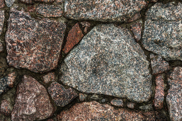 part of the wall of uneven stones natural granite