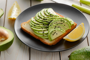 Perfect avocado toast with sesame seeds and lemon