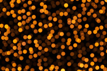 Golden holiday glowing backdrop. Defocused gold bokeh background