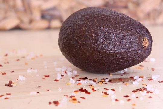whole avocado with salt and chille on the table