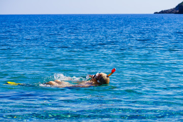 Man with snorkeling tube in sea