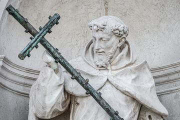 Saint George statue with big cross at the facade of Church of San Giorgio Maggiore in Venice,...