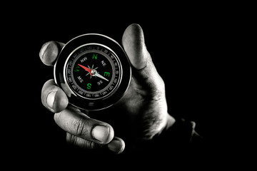 compass pointing west on black background © josecarlos